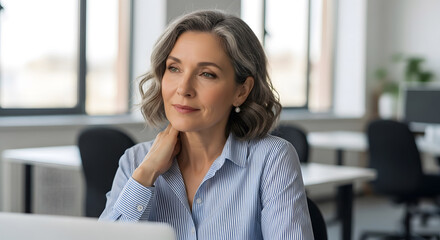 Obraz premium Senior Businesswoman with Gray Hair Looking Thoughtfully in Office. 