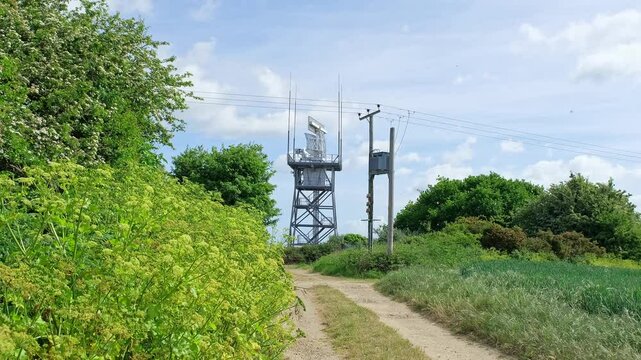 Rotating radar detector carrying out important surveillance on top of a tower in the countryside