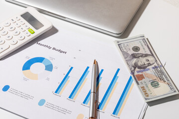 This overhead view highlights essential items for budgeting and expense planning: a calculator,...