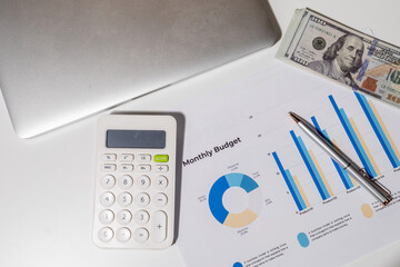 This overhead view highlights essential items for budgeting and expense planning: a calculator,...