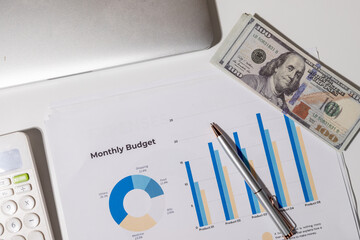 This overhead view highlights essential items for budgeting and expense planning: a calculator,...