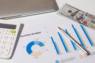 Home Office Budgeting Tools with Cash, Graphs, and Laptop