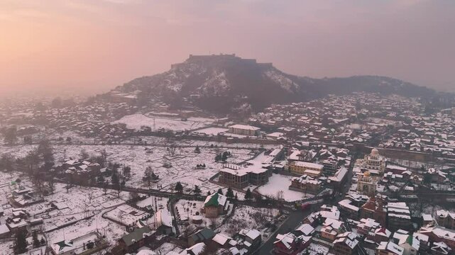 Pull in Drone visuals of the snowy landscapes around Hari Parvat in Kashmir.