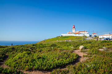 Summer view of Cabo da Roca Lighthouse, cliffs and Atlantic Ocean, Portugal. Cabo da Roca is a western point of Europe