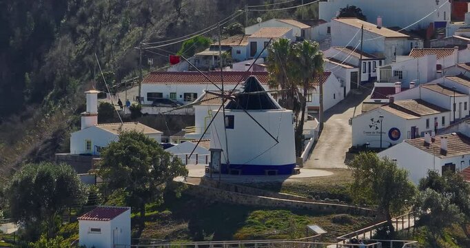 Aerial view of small village with windmill and picturesque rooftops, Odeceixe, Portugal