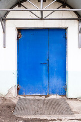 Fototapeta premium closed blue painted steel double door in building