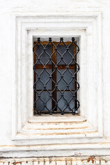 Fototapeta premium window with openwork lattice in old monastery wall