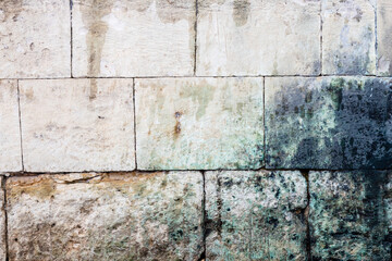 lichen covered old stone wall in monastery