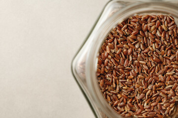 Organic brown rice resting in a clear glass jar showcasing its rich texture