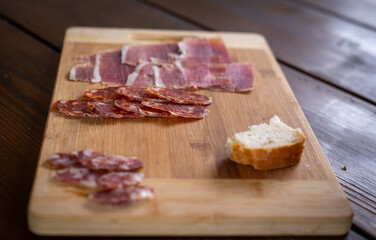 Charcuterie board with smoked ham and pršut