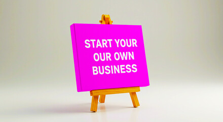 Pink canvas with start your own business text on a small wooden easel against a gray background