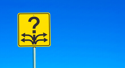A yellow sign with a question mark and arrows pointing in different directions against a blue sky