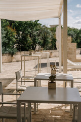 table and chairs on the terrace in an old European town, aesthetic minimal picture