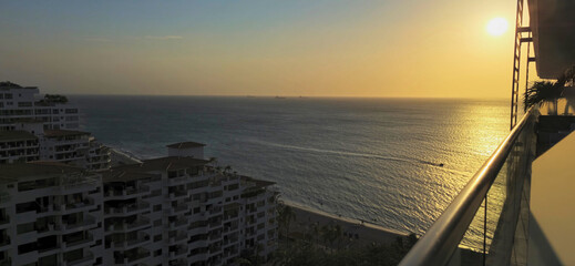 The sea, a hotel, and the sunset, at nightfall