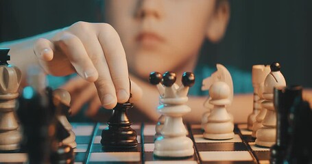 Close-up view of an 8-year-old boy playing chess, moving pieces thoughtfully on a wooden chessboard. Child strategy, focus, and logic development. - Powered by Adobe