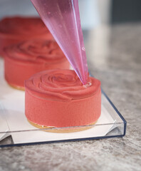 Pastry Chef Finishing a Rose-Shaped Mousse Petit G&acirc;teau with Elegant Decoration