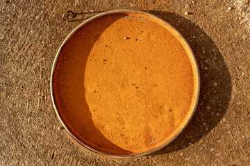 Rust on a metal flat dish. Natural oxidation.