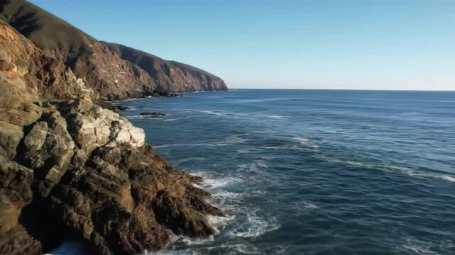 Aerial View of Ocean Waves Crashing on Coastal Cliff