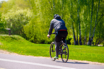 Cyclist ride on the bike path in the city Park
