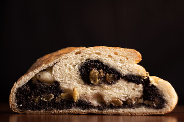 Close-Up of Traditional Poppy Seed Roll Dessert on a Wooden Surface