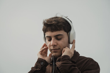 Man Feeling Free While Listening To Music On The Shore During Winter 