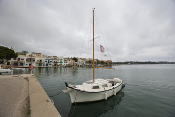 Sailboat docked in portocolom harbor on overcast day in mallorca