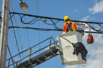 Utility Worker on Lift Repairing Power Lines