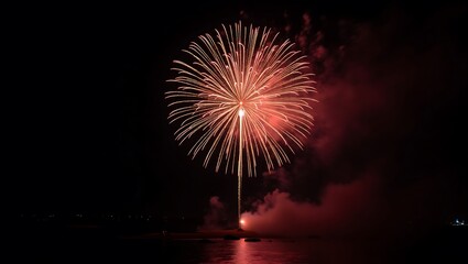 Spectacular Fireworks Display Over the Water with Golden Radiating Patterns