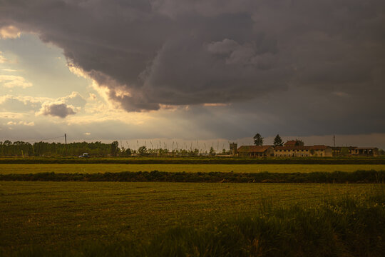Dramatic Rural Landscape with Sunrays and Overcast Sky
