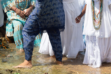 People are seen on the edge of Rio Vermelho beach paying homage to Iemanja in the city of Salvador, Brazil.