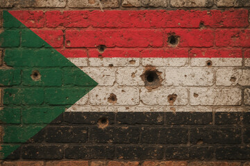 Naklejka premium Sudan Flag Bullet Hole Wall