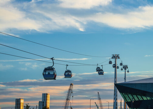 Modern Cable Car System Soaring Above the City Skyline at Sunset in Greenwich, London

