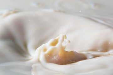 Close up shot of splashing fresh milk on container