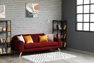 Interior of living room with red sofa and bookshelves