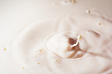 Close up shot of splashing fresh milk on container