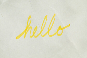 handwritten "hello" script in yellow highlighter marker