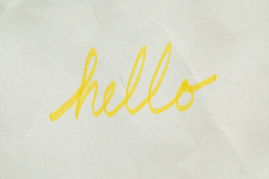 handwritten "hello" script in yellow highlighter marker