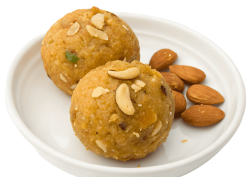 Two laddus garnished with nuts isolated on transparent background, with almonds