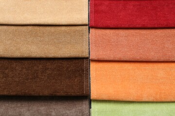 Samples of different fabrics as background, top view
