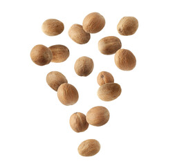 Aromatic nutmeg seeds falling on white background