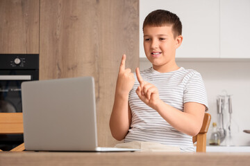 Mute boy using sign language during video call at home
