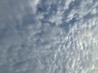 a sky filled with altocumulus clouds with a wavy pattern, creating an interesting texture in the...