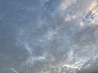 a sky filled with altocumulus clouds with a wavy pattern, creating an interesting texture in the...