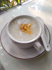 A bowl of hot white rice porridge on the table