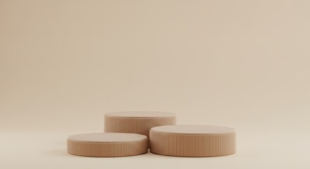 Three beige cylindrical podiums for product display in a minimalist studio setting