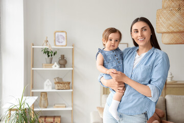Mother holding her baby at home