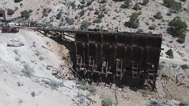 Horn Mine near Milford, Utah. Low level shot of the ore hopper bins that rises to show the machinery shop and head frame.