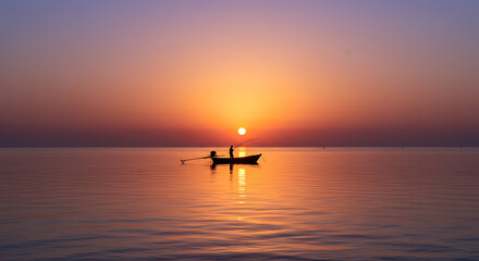 Serene Sunrise Seascape Fisherman in Small Boat at Dawn