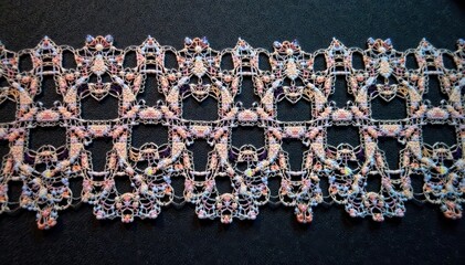 Geometric lace motif, sharp lines, black thread, texture, craft, dark