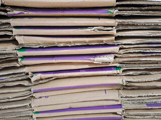 stack of cardboard, pile of waste corrugated cardboard used in packaging for recycling. Stack of brown cardboard boxes stacked on top of each other. the boxes appear to be old and worn	
